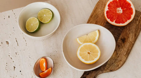 Assorted citrus fruits including lime, lemon, orange, and grapefruit on a kitchen table
